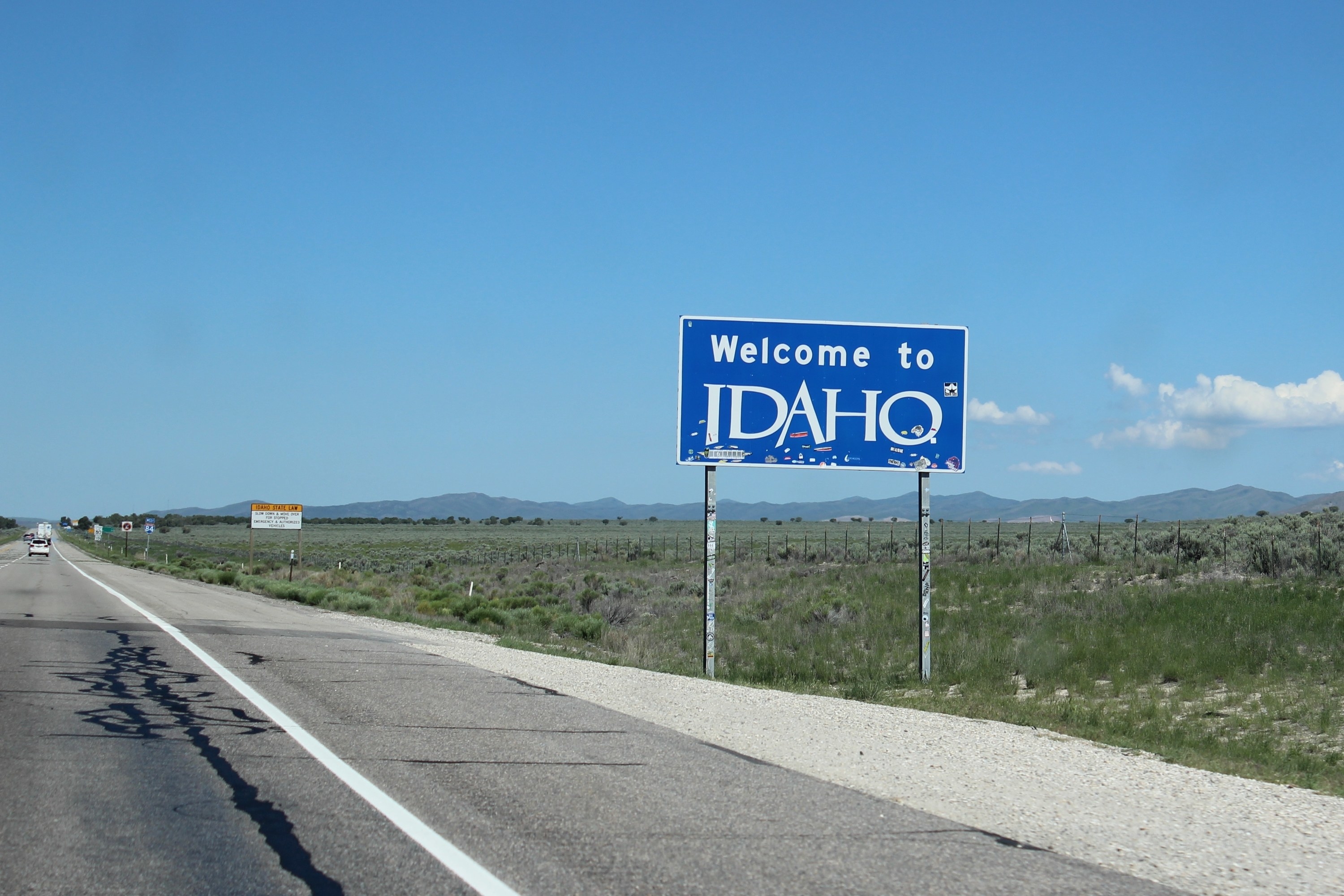 the Welcome to Idaho sign on the side of the highway