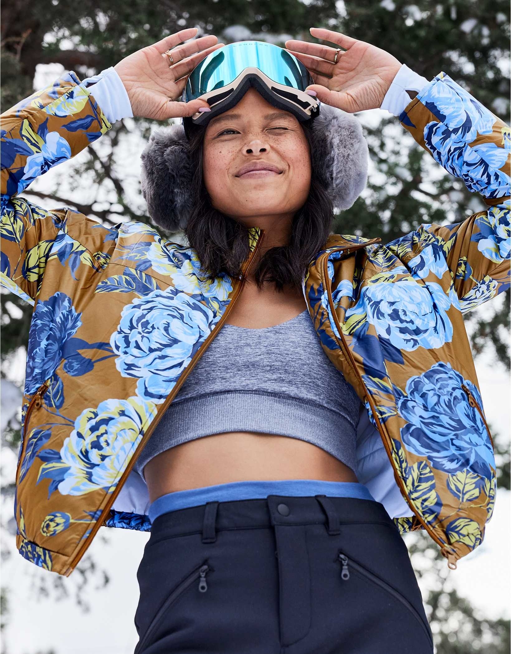 a model in a brown puffer cropped coat with blue florals on it