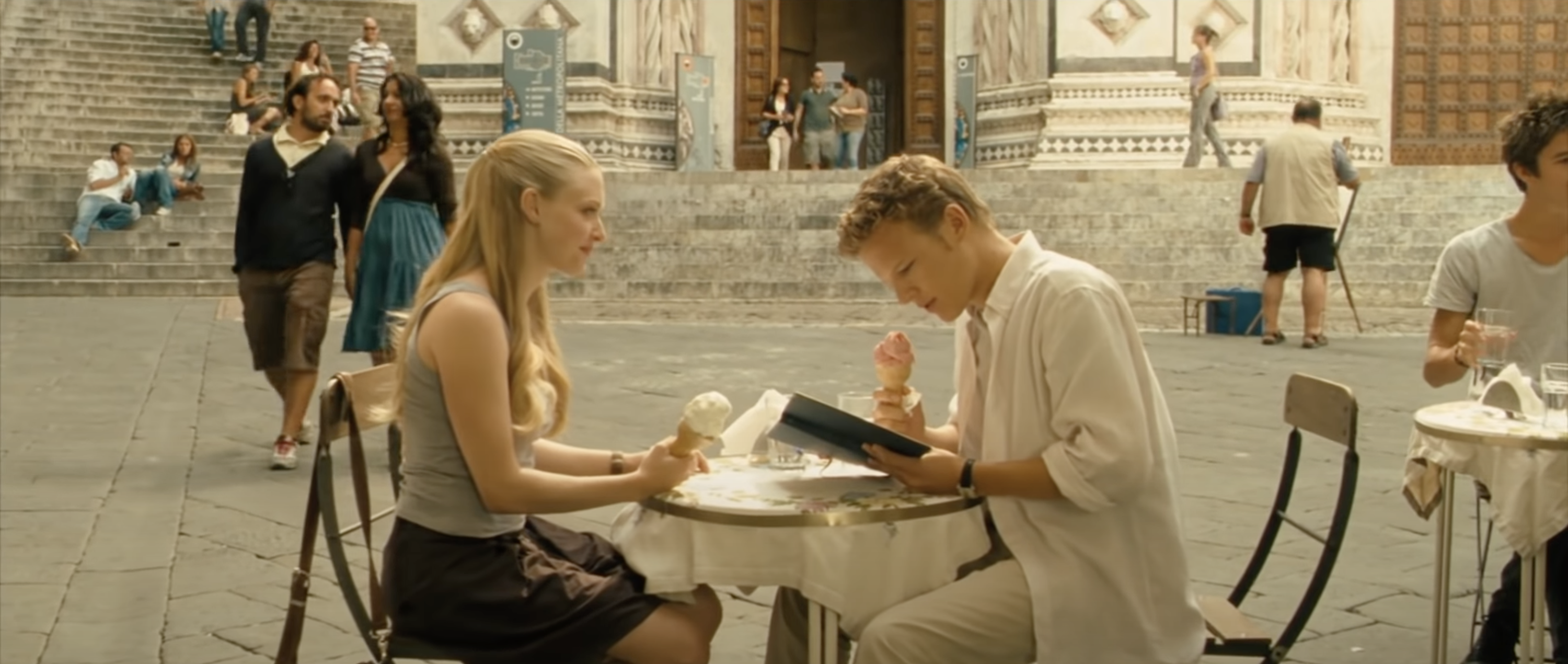 Amanda Seyfried as Sophie and Christopher Egan as Charlie sit together in Italy in &quot;Letters to Juliet&quot;