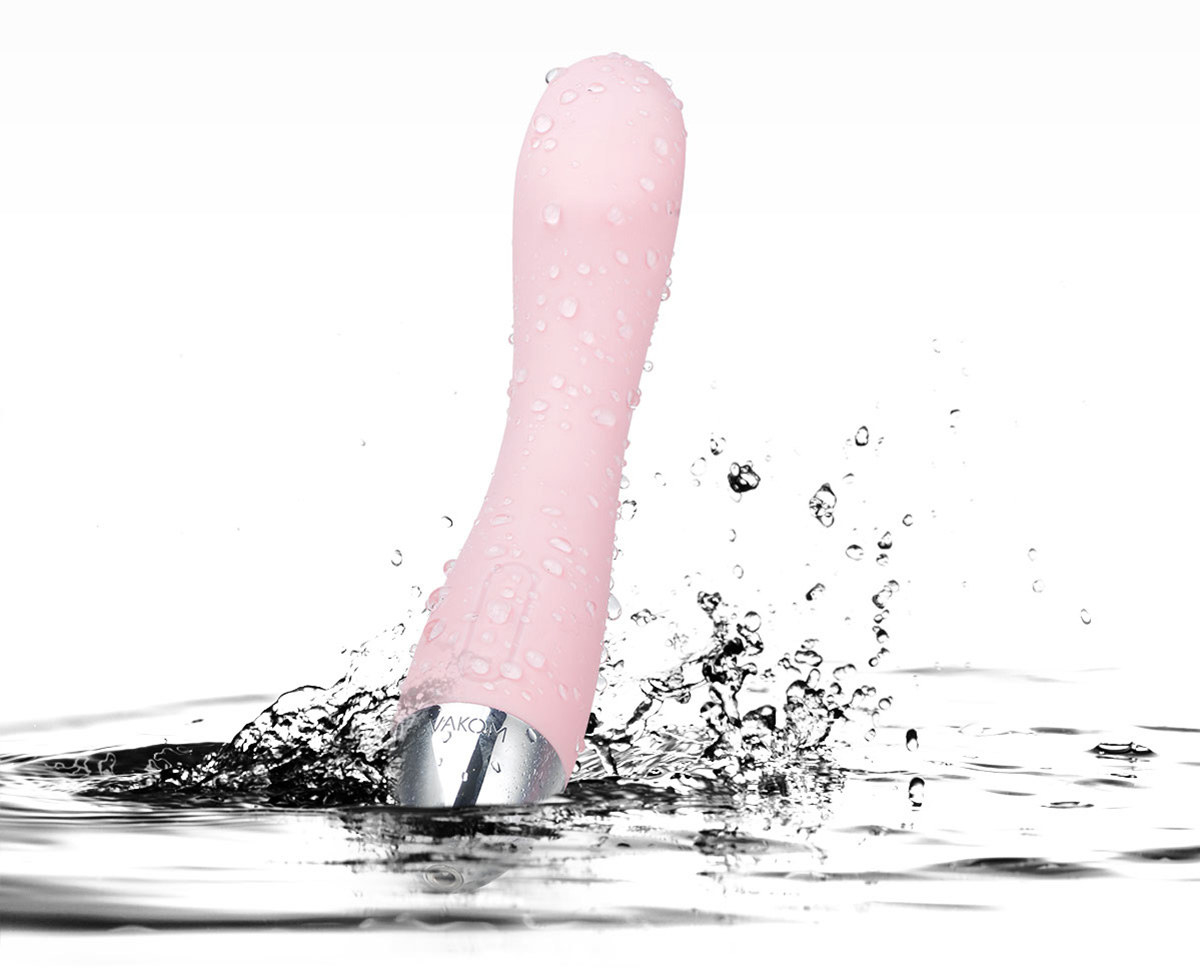 Pink vibrator splashing in water