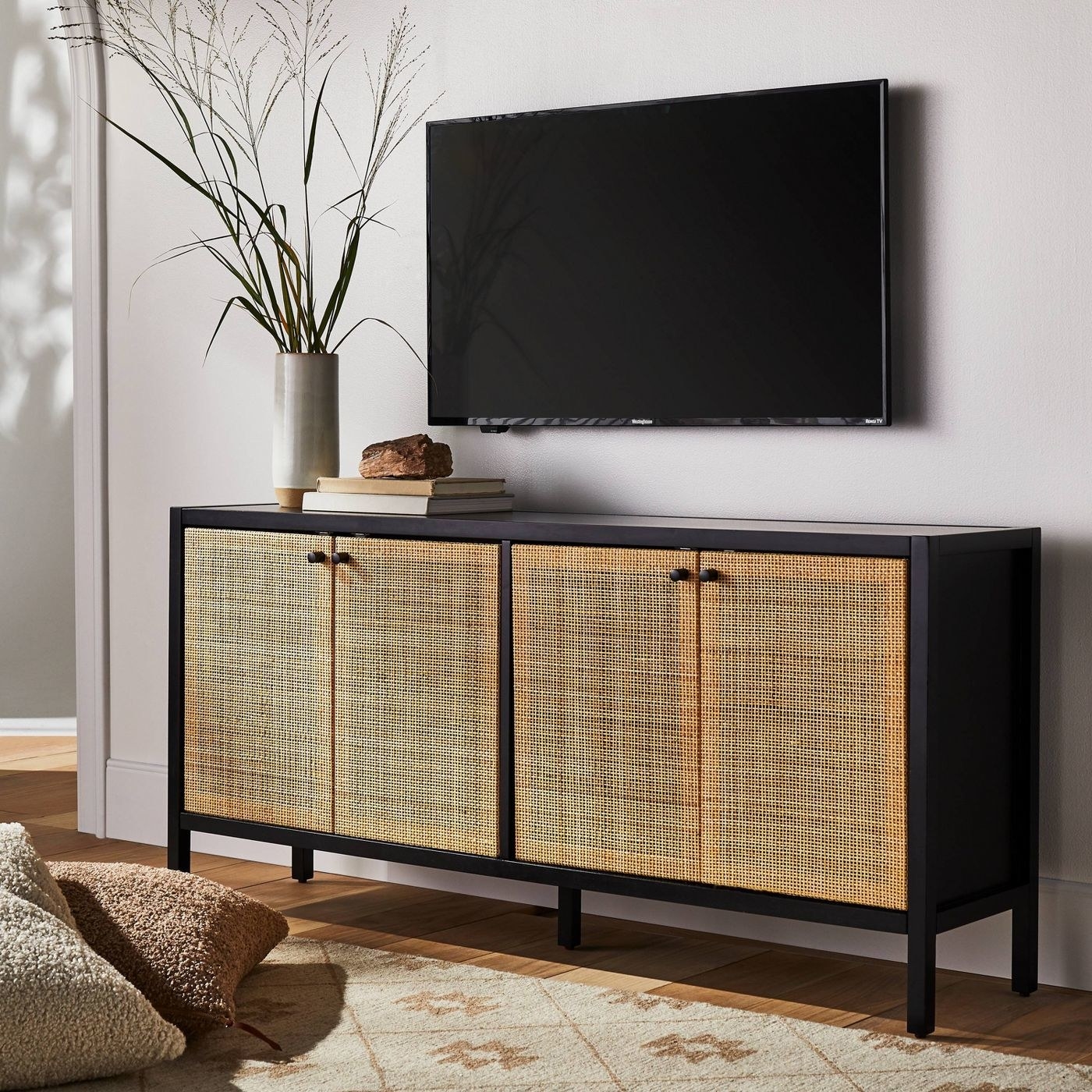 the dark TV stand with light cane doors