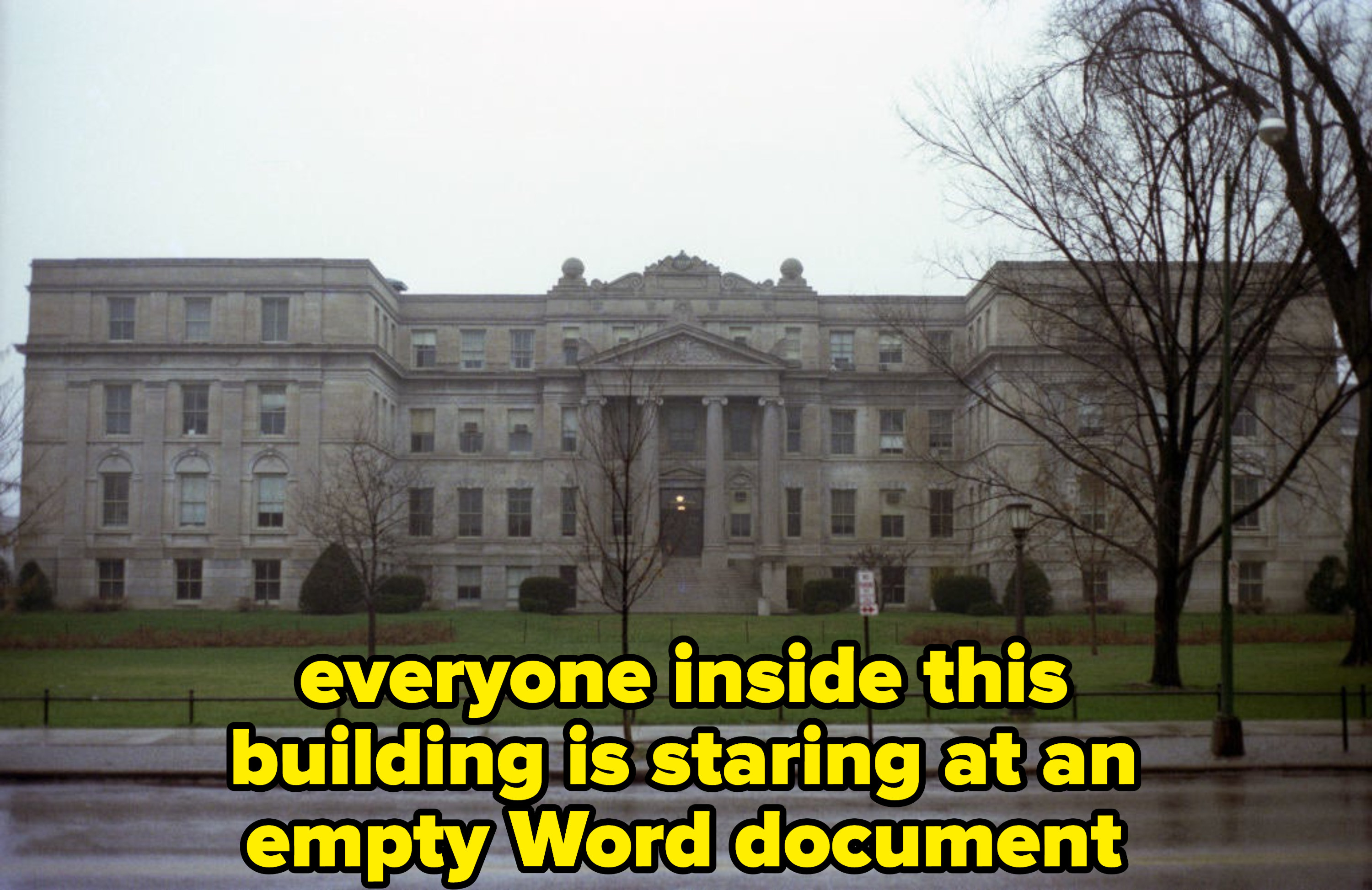 the main building of Iowa University, with caption: everyone inside this building is staring at an empty Word document