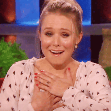 Kristen Bell touching her hand to her heart and other hand to her face on the Ellen show