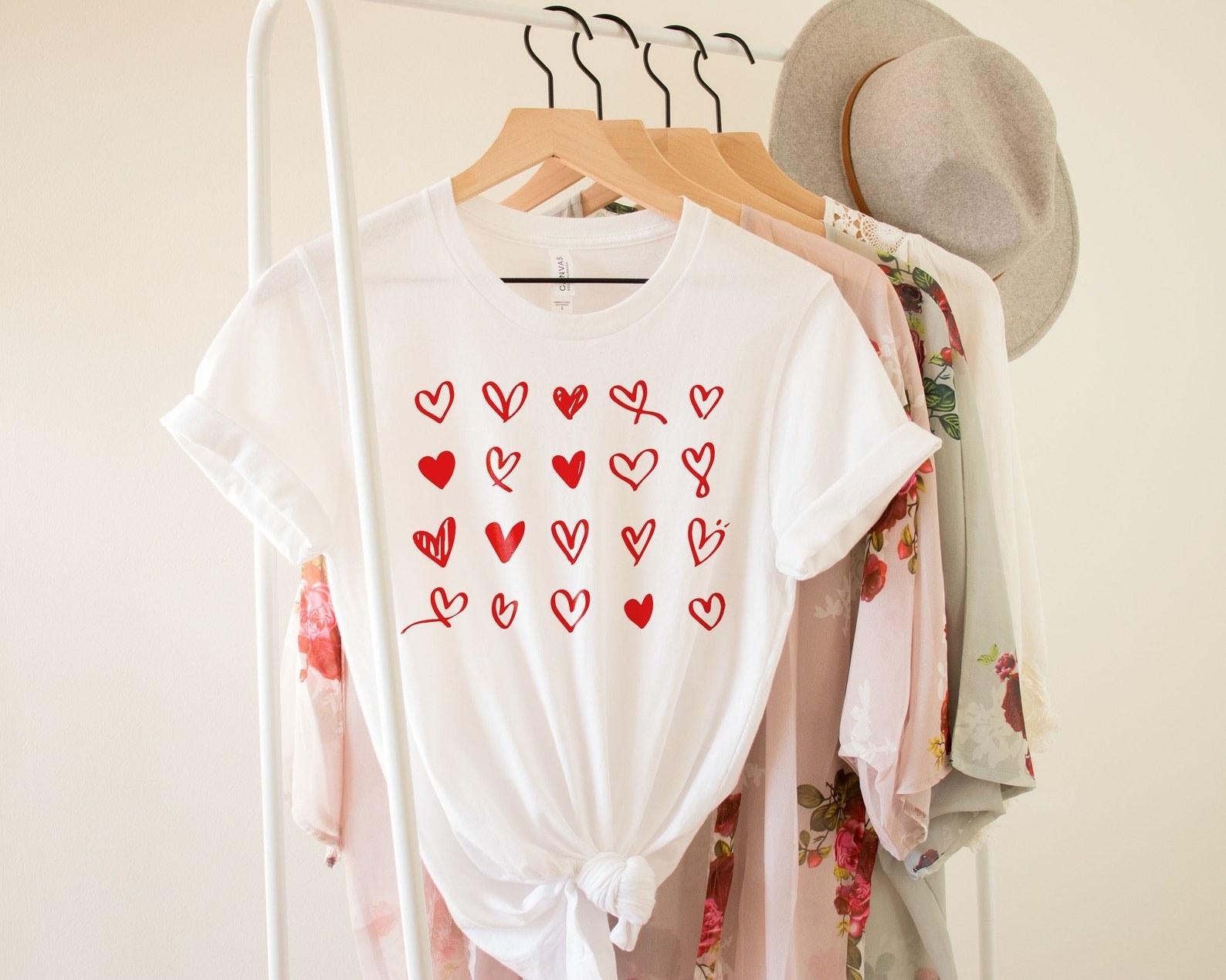 Heart-printed t-shirt hanging on a hanger