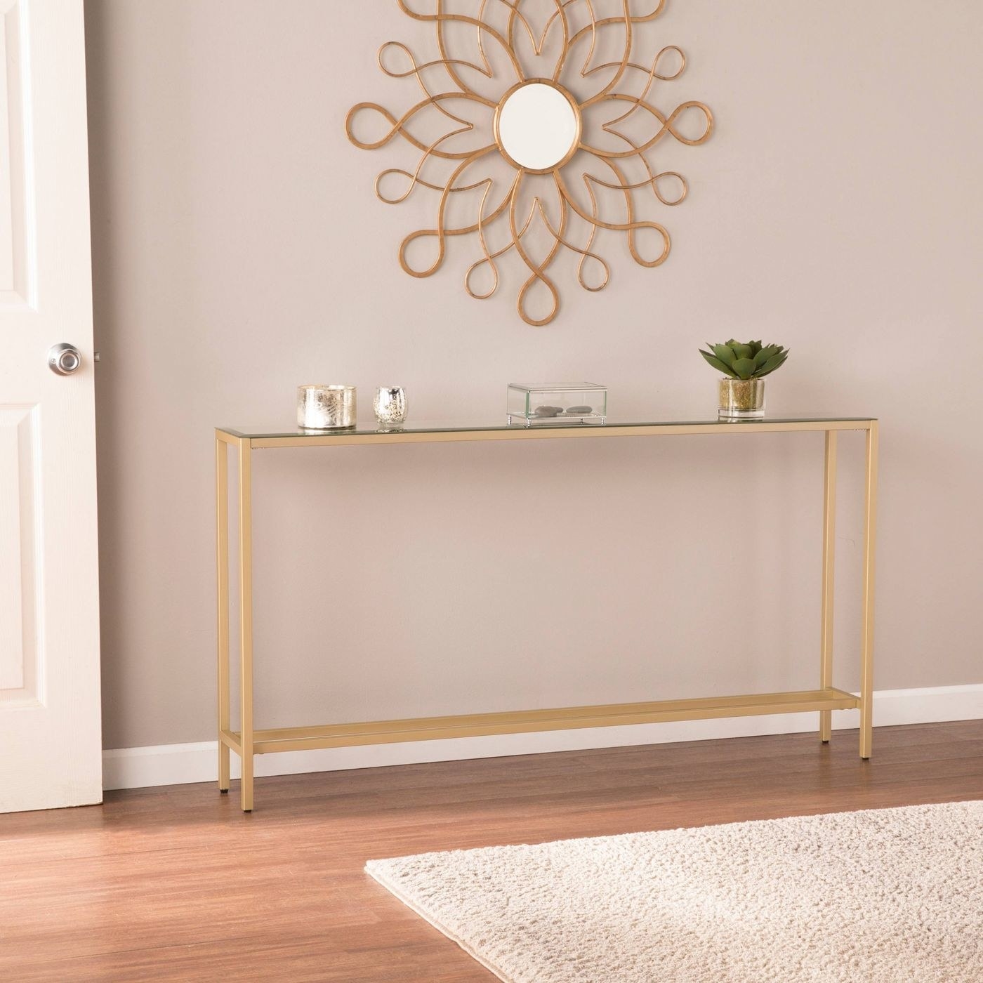 the mirror-topped, gold legged table in an entryway