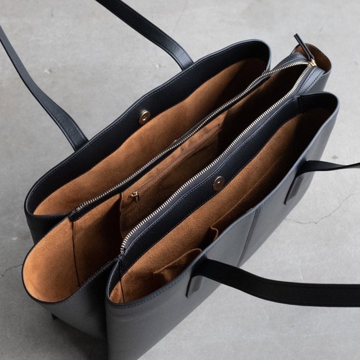 A top-down view of the tote showing three compartments with both zip and snap closures