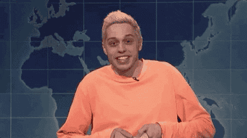 Pete Davidson putting on a