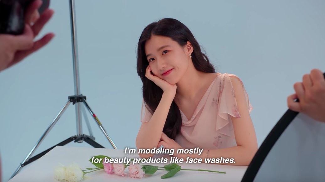 Su-min smiles angelically, posing for a photo, her voiceover says &quot;I model mostly for beauty products like face washes&quot;