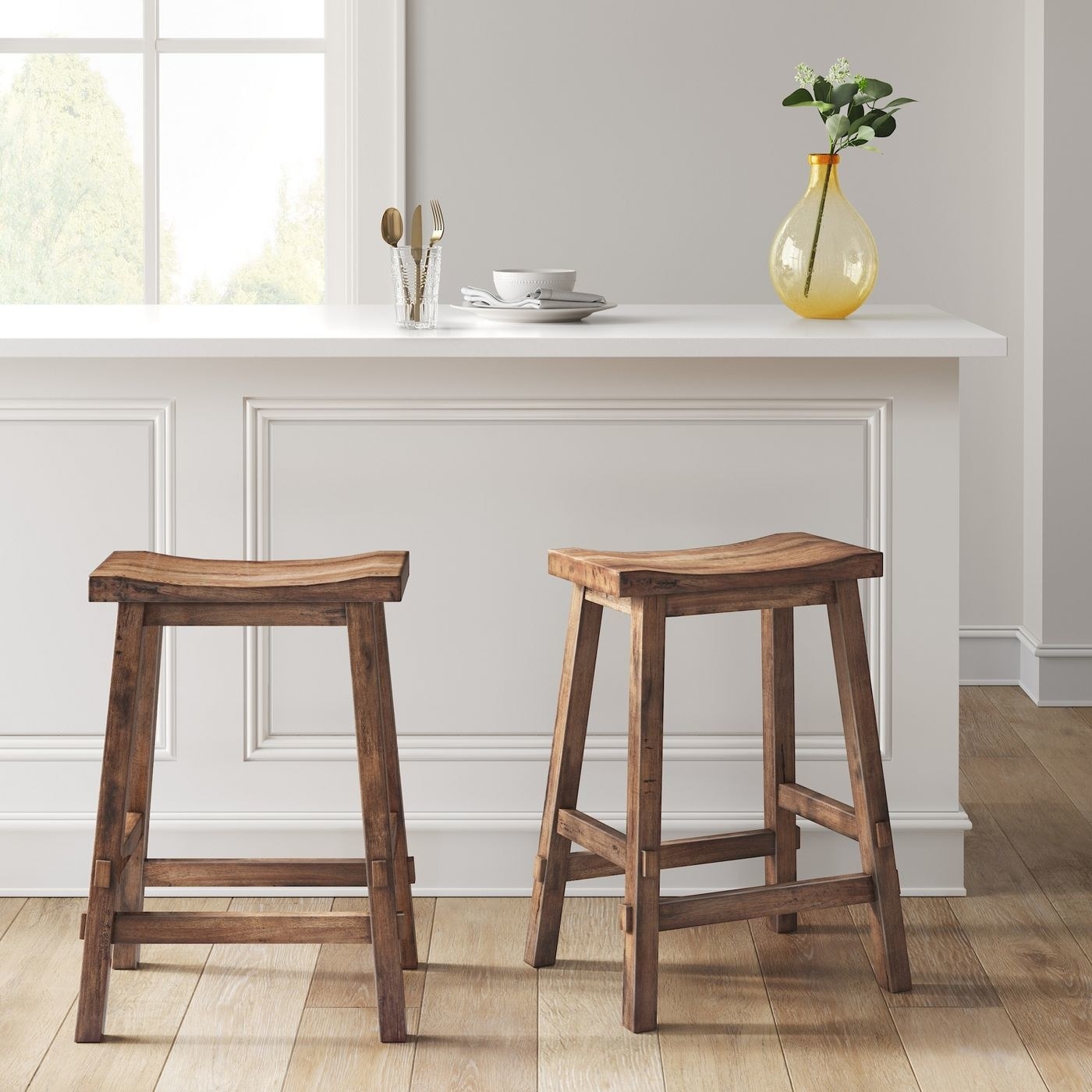 the two brown wood stools under a countertop bar