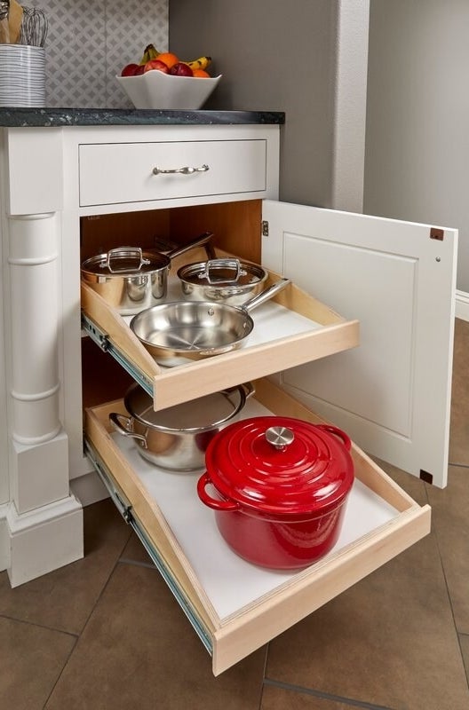 An image of a slide-out-shelf cabinet retrofit used to store pots and pans