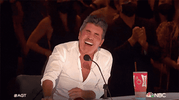 Simon Cowell cracks up while judging on the panel of
