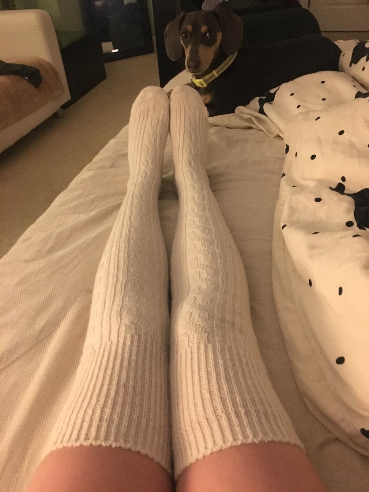reviewer wearing over-knee wool socks in white