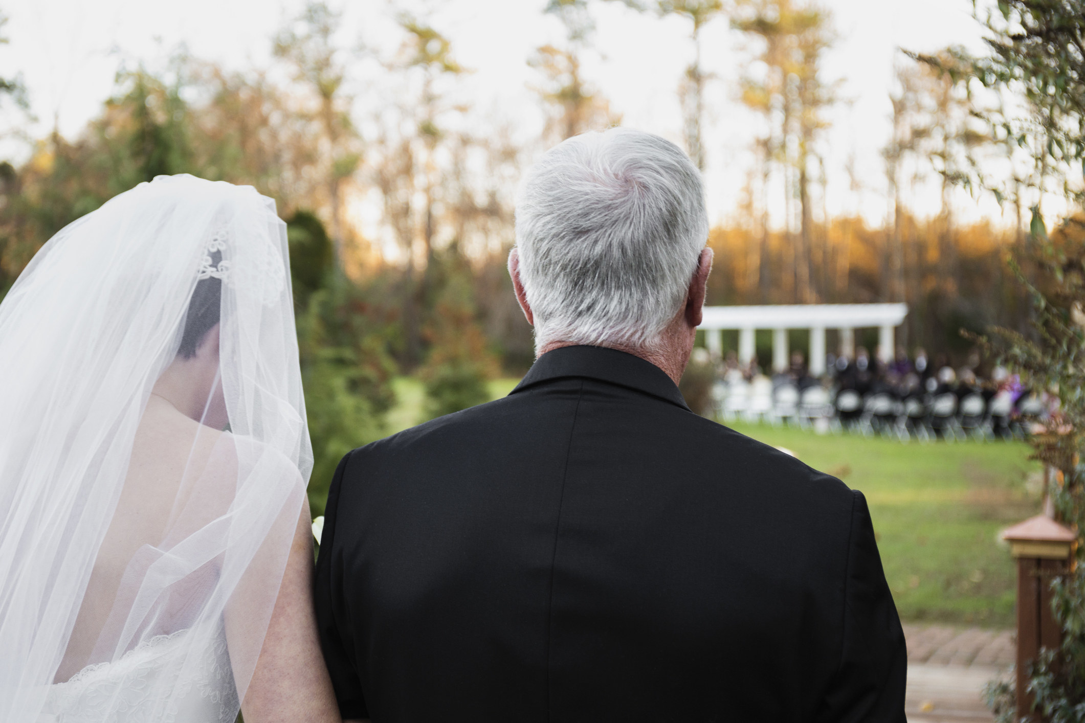 A bride walks down the aisle with her father