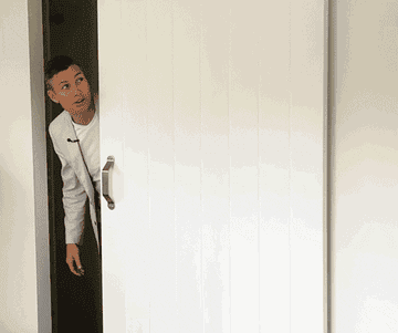 Man opening barn door and saying