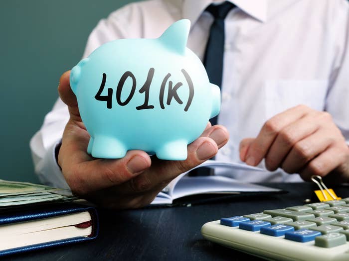 Person holding a piggy bank labeled 401k