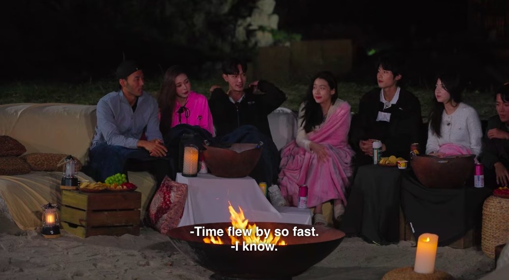 Everyone sits around the firepit, with Ji-a cozy next to Hyeon-joong