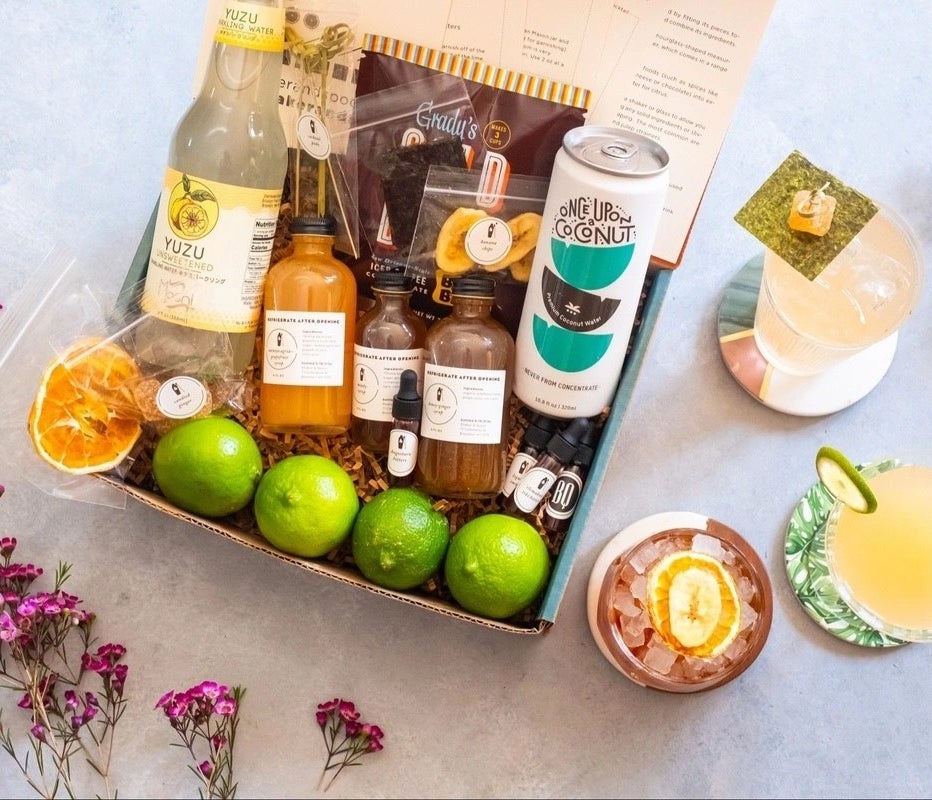 a cocktail kit featuring fruit, juices, bitters, and other ingredients