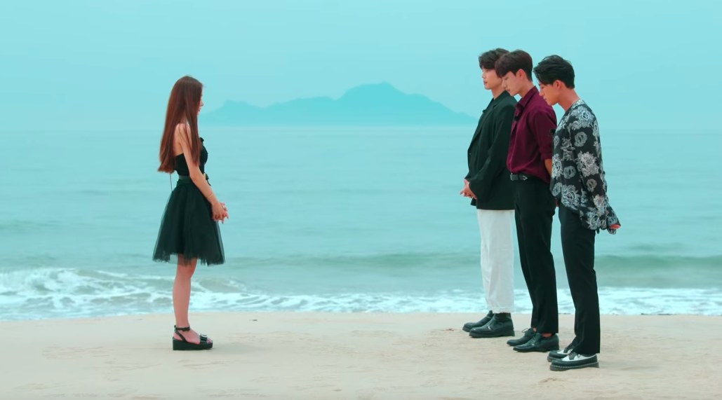 Jia stands in front of the three men who have chosen her