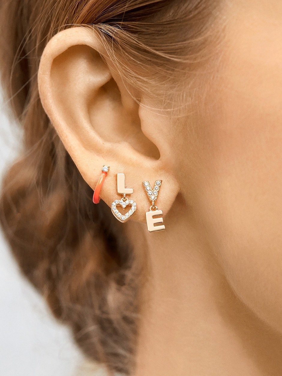 model wearing the earrings that spell out &quot;lo&quot; on one and &quot;ve&quot; on the other