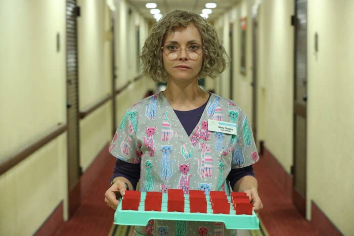 Christina as a nurse carrying a tray in a scene from Yellowjackets