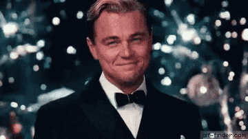 Leo&#x27;s character in the Great Gatsby raising a glass in cheers as fireworks go off behind him