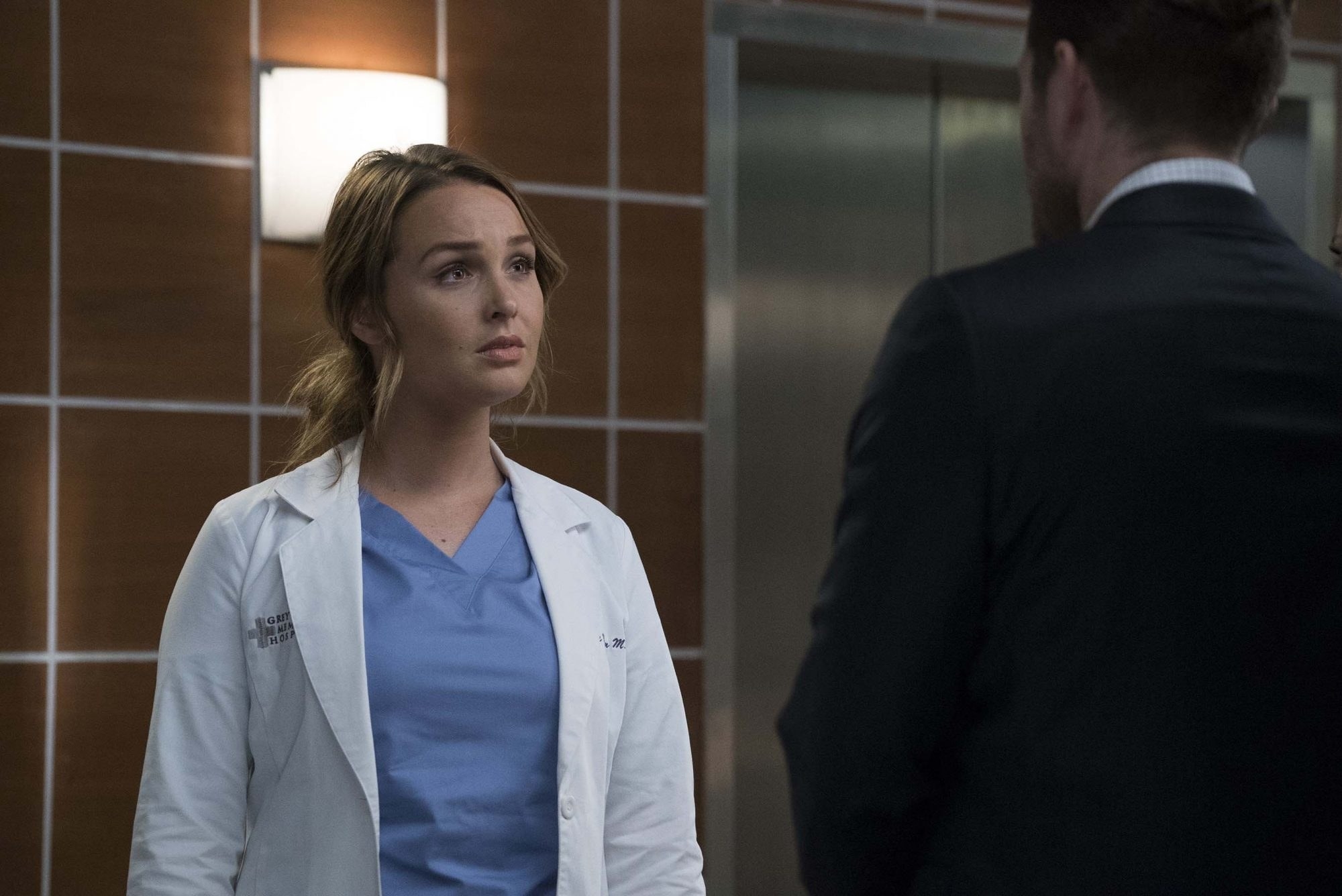 A still from Grey&#x27;s Anatomy showing Dr Jo Wilson talking to a man outside an elevator
