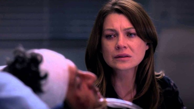 Meredith Grey looking at Derek in a coma in a hospital bed