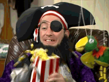 Patchy the Pirate shakes a bag of popcorn