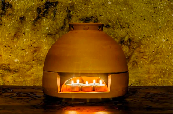 the terra cotta heater with candles inside of it