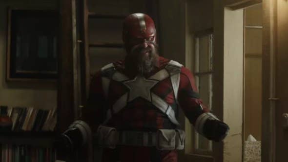 red guardian, a man with a long beard who wears a helmet and tight bodysuit with a star on it