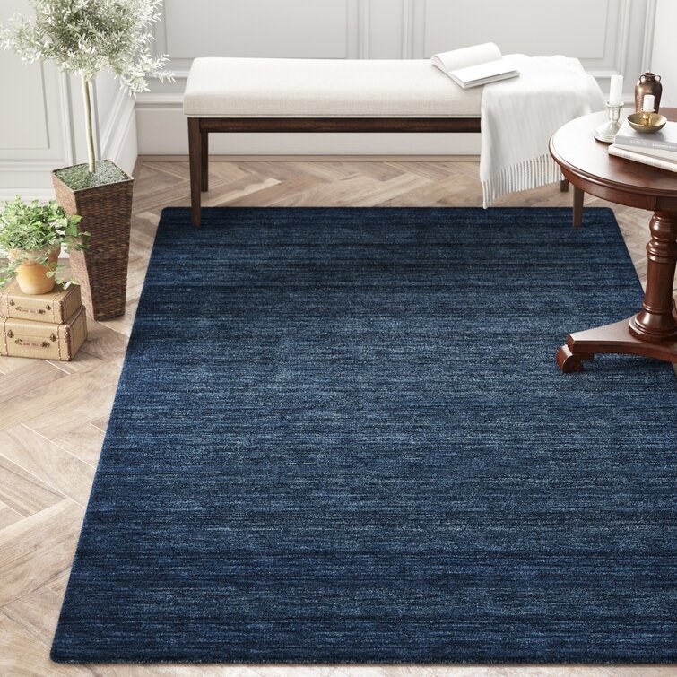 the wool rug in dark blue