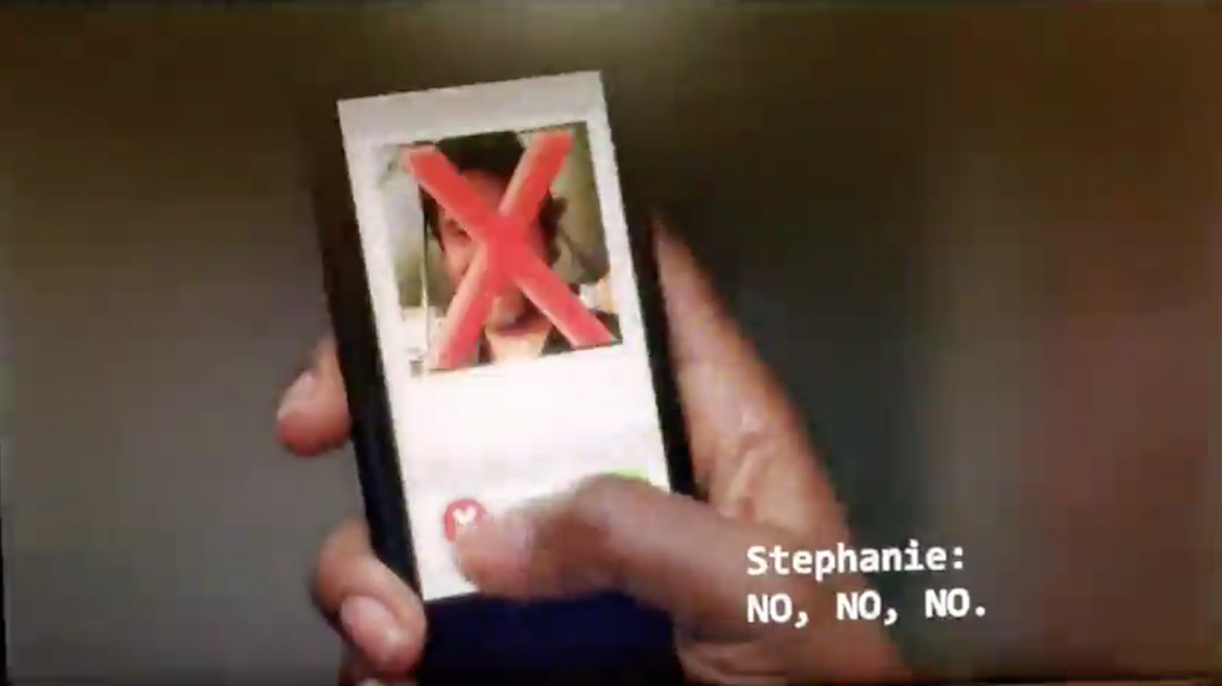 A hand holding a phone with a photo of a man and a red X through his photo