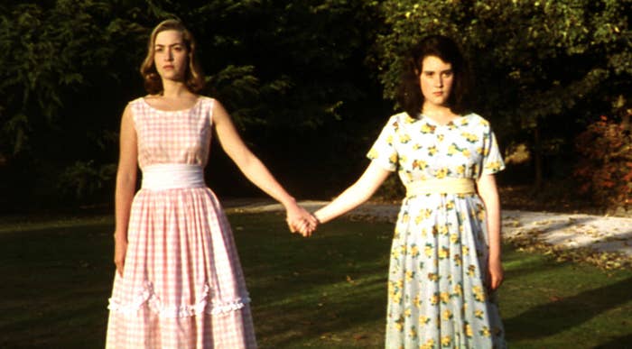 Melanie and Kate Winslet holding hands outside in a scene from Heavenly Creatures