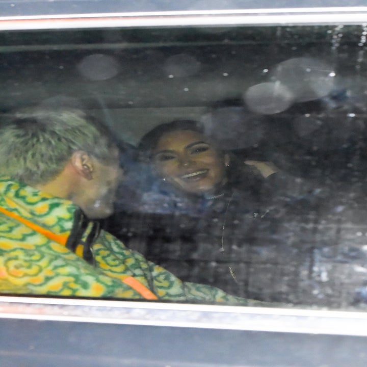 Paparazzi shot of Pete (L, his back to the camera) and Kim laughing in a car