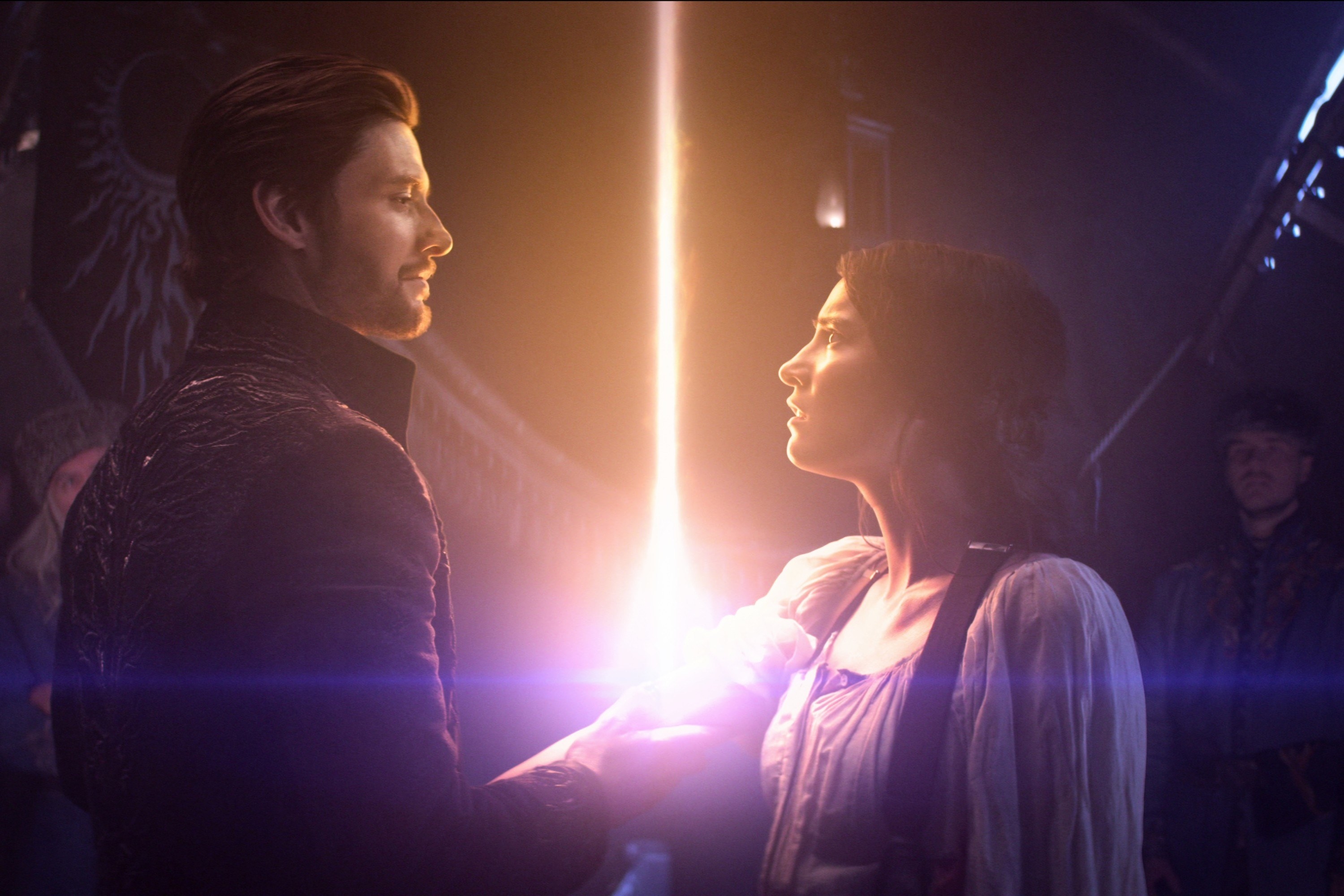 Still from &quot;Shadow and Bone&quot; featuring Ben Barnes (L) and Jessie Mei Li (R). A beam of light escapes from the latter&#x27;s arm as the former holds it