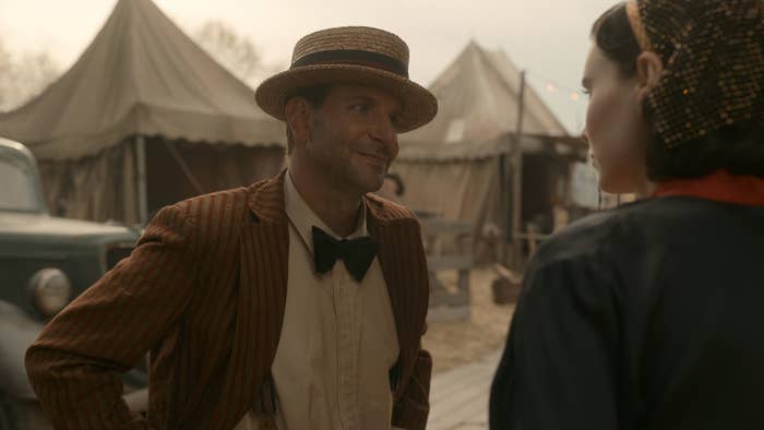 Cooper smiles while wearing a hat and bow tie