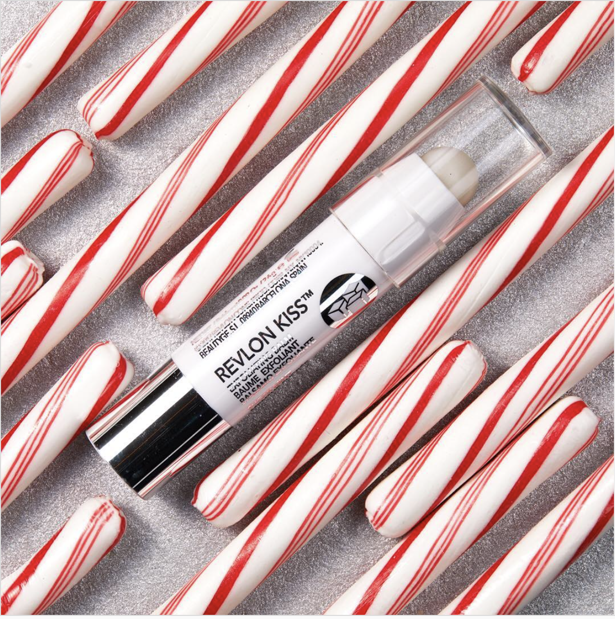 The lip scrub laying amidst many candy canes
