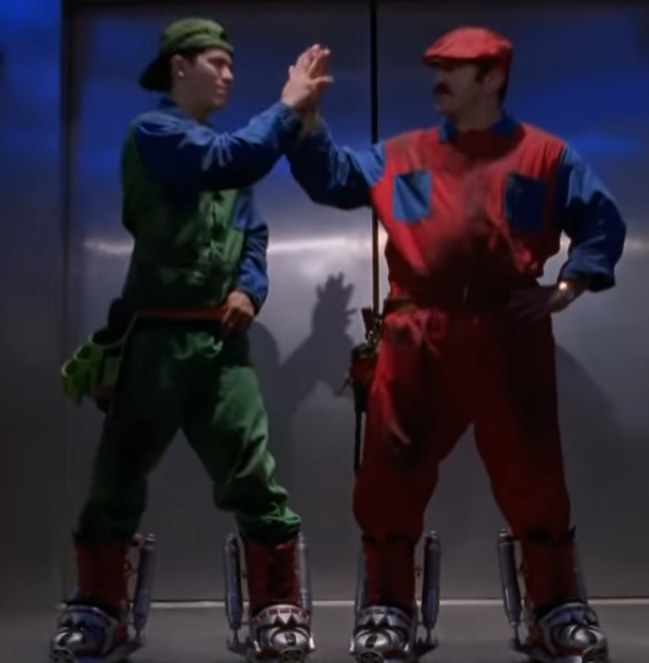 John Leguizamos Luigi and Bob Hoskins Mario high fiving each other in an elevator
