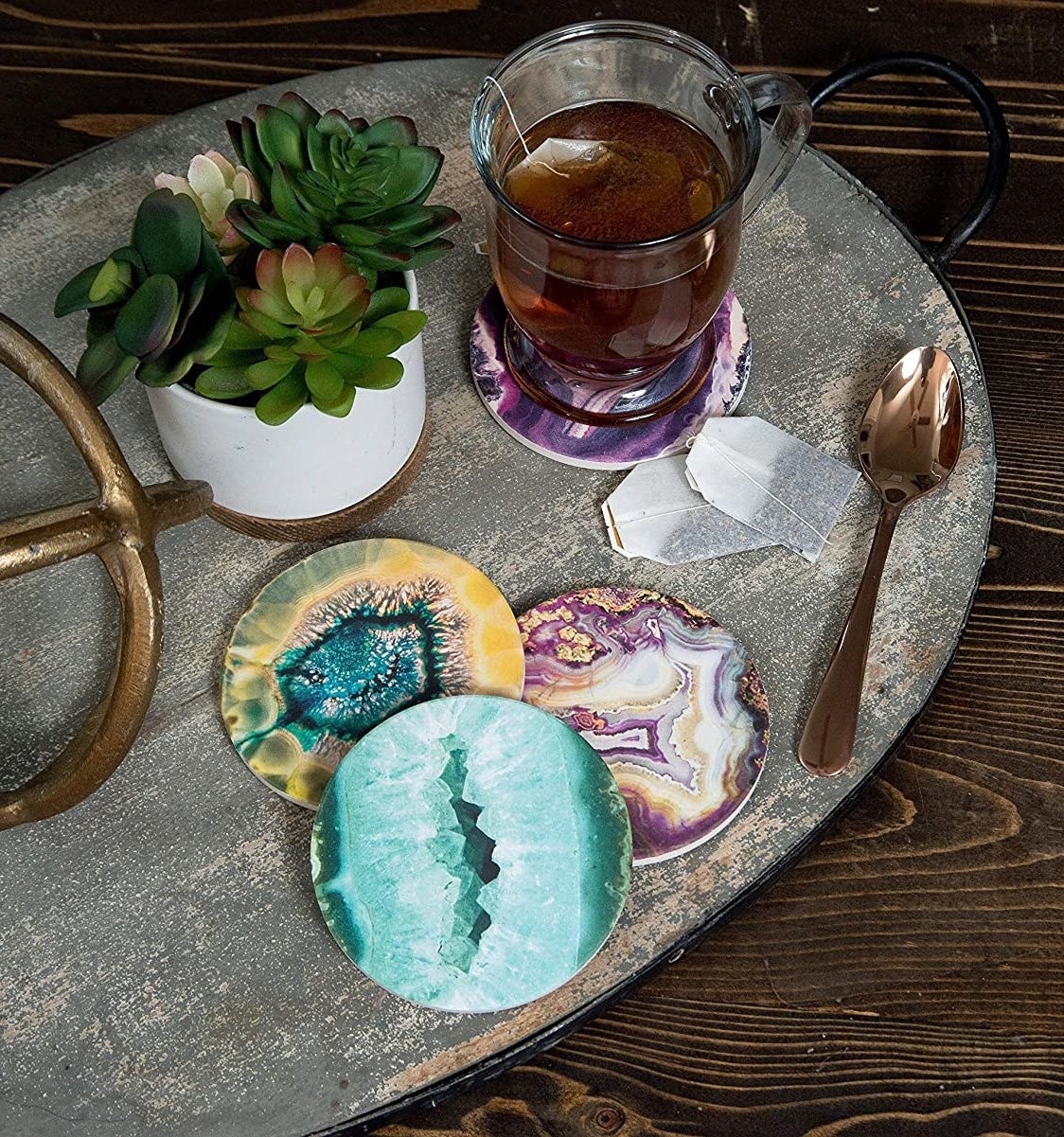 a set of four gemstone coasters on a coffee table