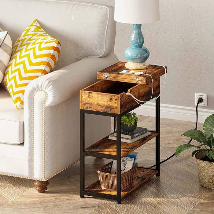 a slim side table with several devices charging up on it