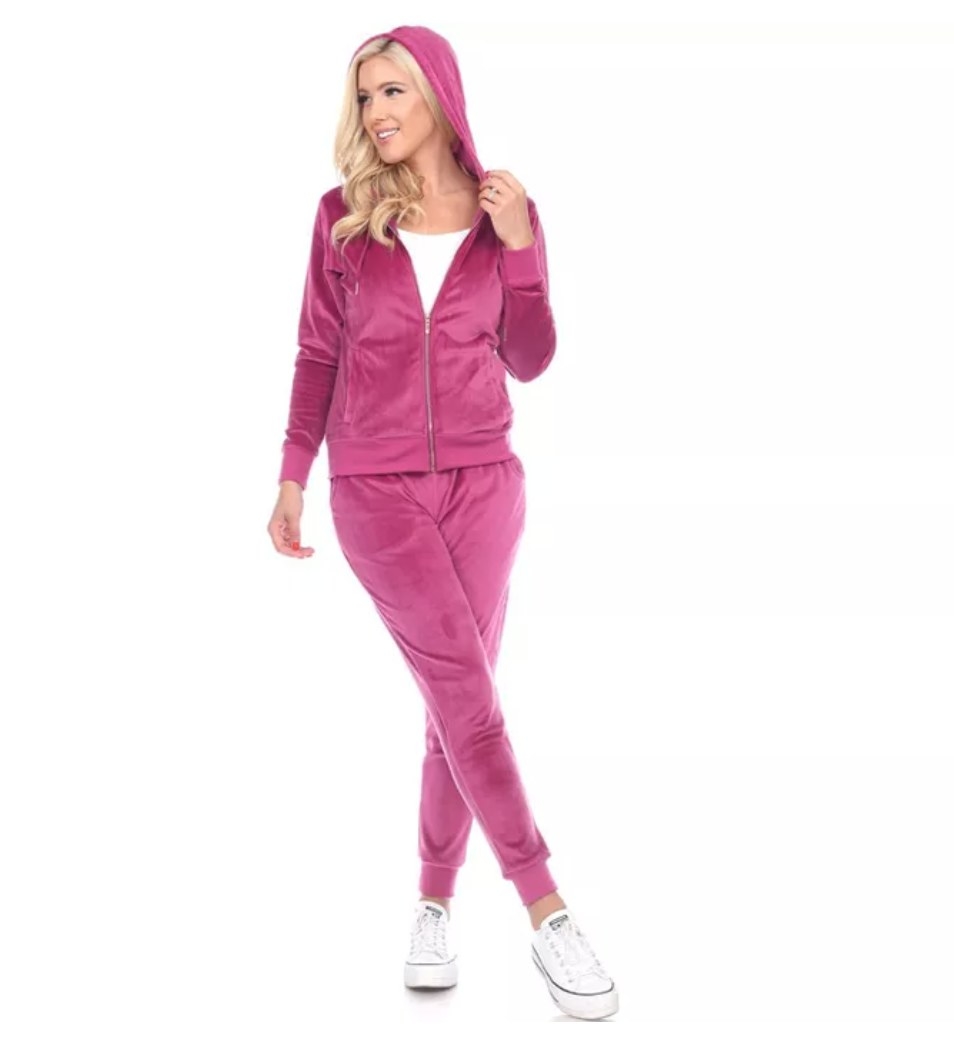 a model wearing the tracksuit in pink