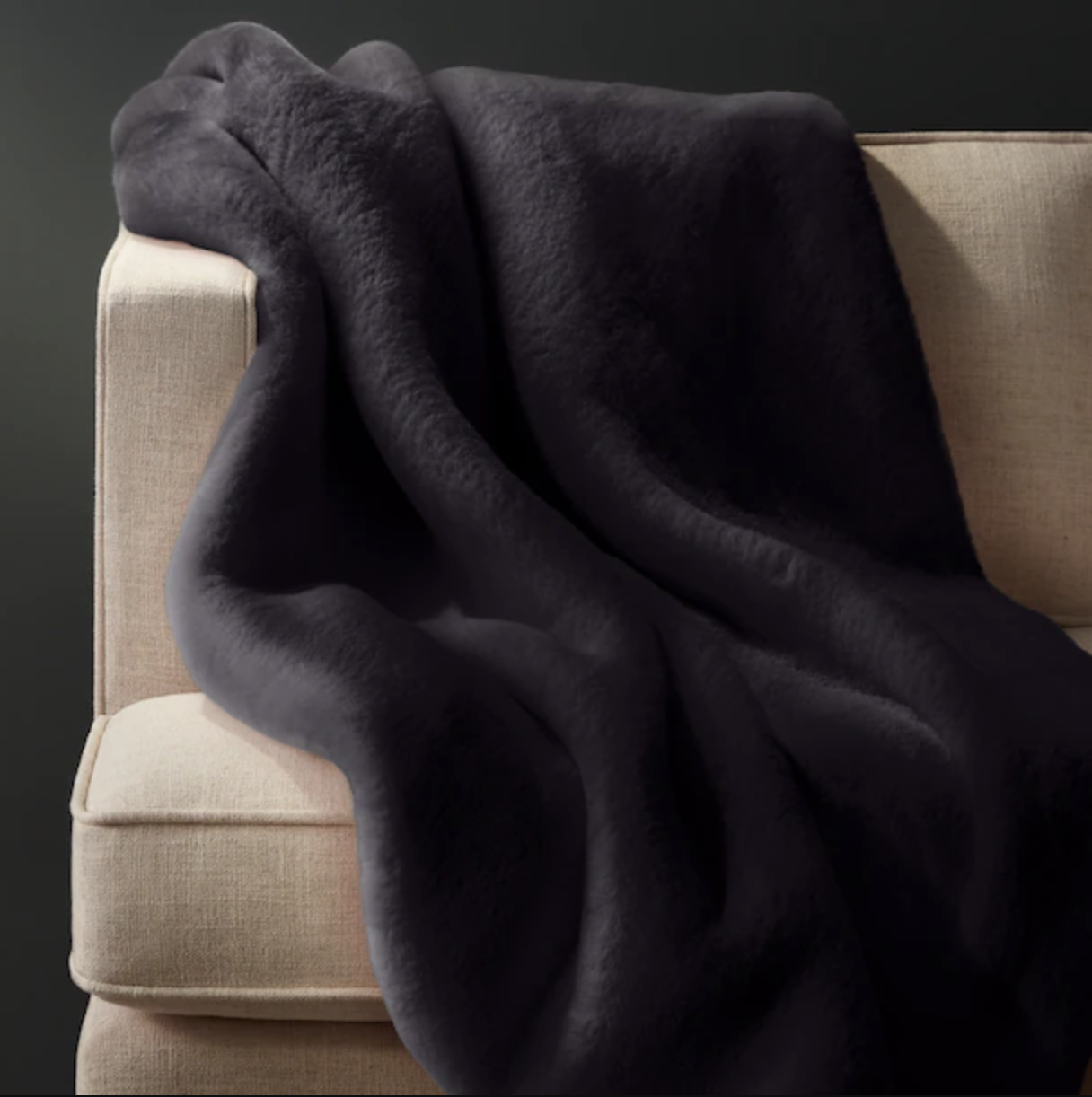 an ultra-fluffy faux fur blanket draped over a sofa