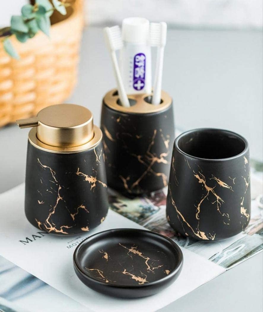 a four piece set of faux marble bathroom accessories