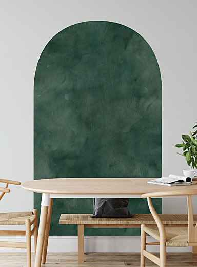 An arch peel and stick wall decal on a plain wall behind a dining room table