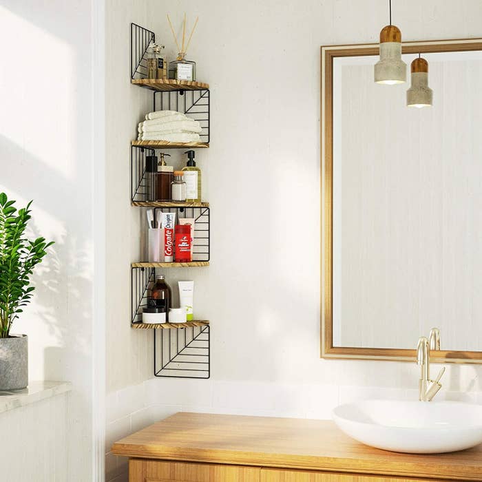 a tall corner shelf with patterned grating in a bathroom