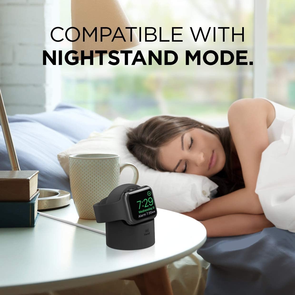 An apple watch on the stand on a bedside table