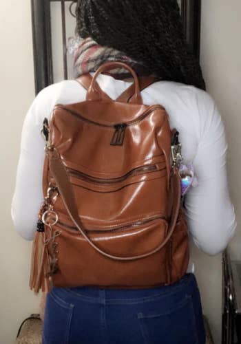 reviewer wearing the purse backpack