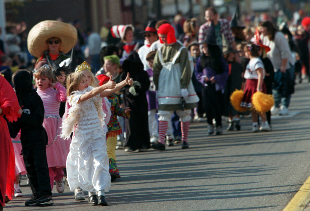 kids in costume march in a modern day Anoka Halloween parade