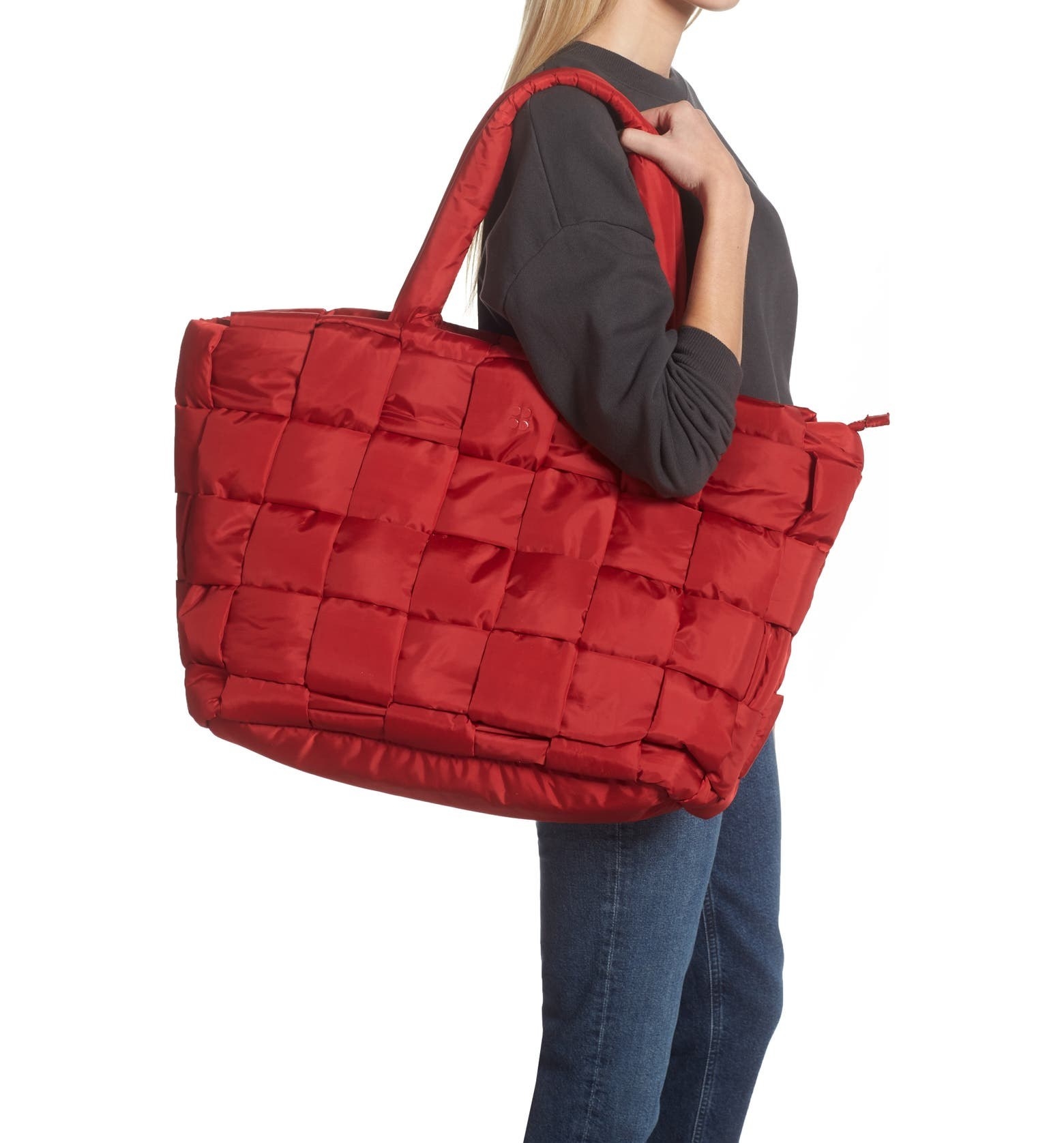 model carrying oversize tote with quited puffer bag