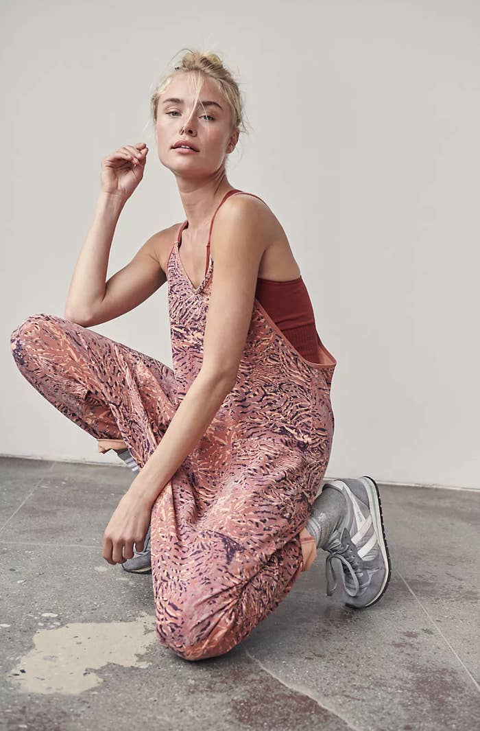 An image of a model wearing an FP Movement printed onesie
